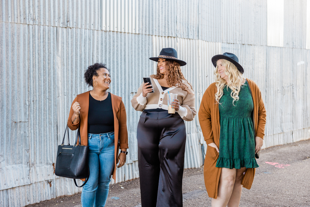 Stylish Plus Sized Women Posing Near Corrugated Metal Wall